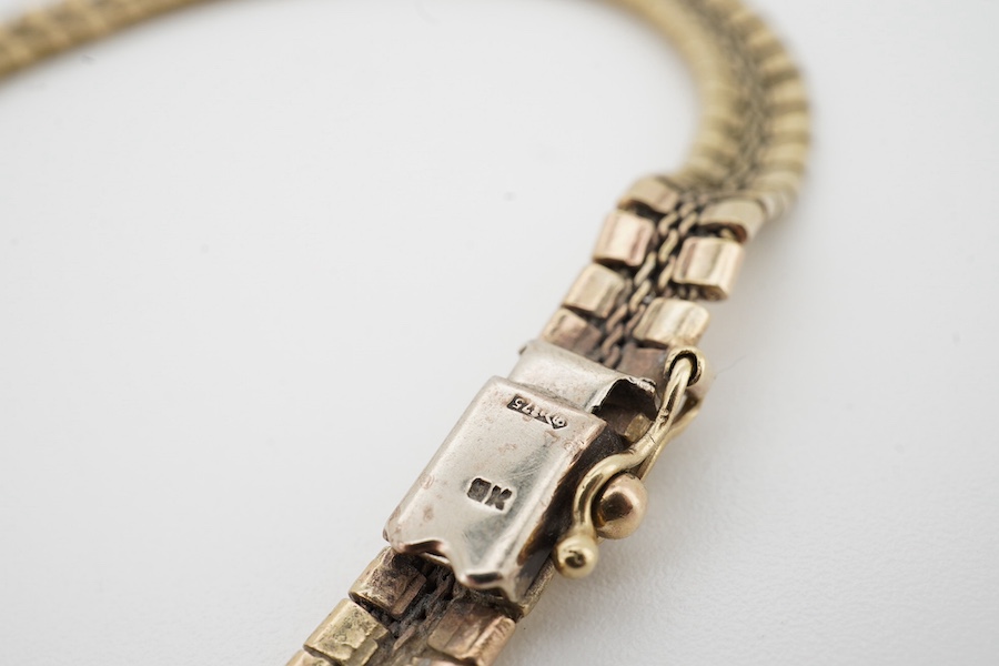 A 9ct gold bracelet, composed of engraved linking, length 21.5cm, British hallmarks, gross weight 13 grams, Condition: fair